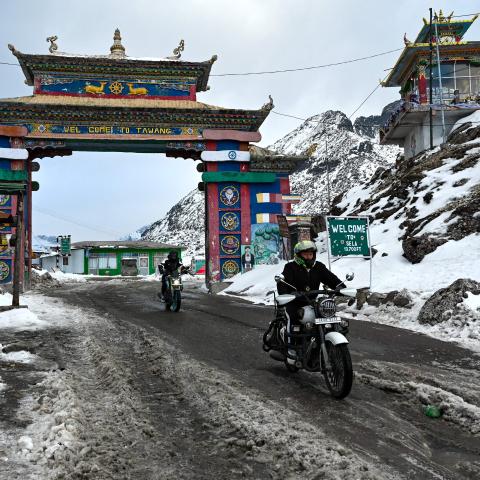 In this picture taken on April 5, 2023, motorbike riders cross into the snow laden Himalayan Sela pass in Tawang in northeast Indian state of Arunachal Pradesh. (Photo by Arun SANKAR / AFP) (Photo by ARUN SANKAR/AFP via Getty Images)