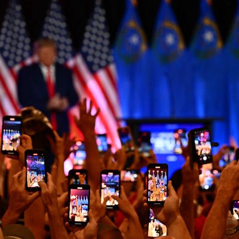 People hold up smart phones to photograph former US President and 2024 Republican Presidential hopeful Donald Trump speak at a Republican volunteer recruitment event at Fervent, a Calvary Chapel, in Las Vegas, Nevada, July 8, 2023. (Photo by Patrick T. Fallon / AFP) (Photo by PATRICK T. FALLON/AFP via Getty Images)