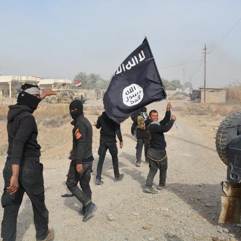 Iraqi government forces celebrate while holding an Islamis Sate (IS) group flag after they claimed they have gained complete control of the Diyala province, northeast of Baghdad, on January 26, 2015 near the town of Muqdadiyah. Iraqi forces have "liberated" Diyala province from the Islamic State jihadist group, retaking all populated areas of the eastern region, a top army officer said today. The symbolic victory for Baghdad, which has at times struggled to push IS back, could clear the way for further adva