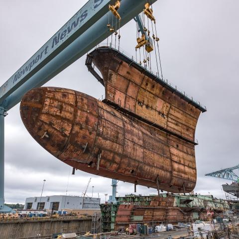 The final piece of the underwater hull of the USS John F. Kennedy (CVN 79) is lowered into place at Huntington Ingalls Industries Newport News Shipbuilding in Virginia on September 28, 2018. (US Navy photo courtesy of Huntington Ingalls Industries by John Whalen)