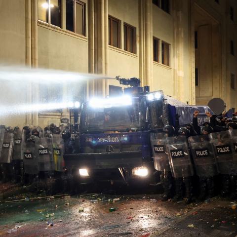 Riot police stand in position on the sidelines of a protest against the government's decision to delay EU membership talks, near the Parliament building in downtown Tbilisi on November 29, 2024. Georgian police fired water cannon and tear gas on demonstrators on the second day of protests against the government's decision to delay pursuing European Union accession. The Black Sea nation has been plunged into political crisis since contested parliamentary elections last month, with thousands rallying outside 