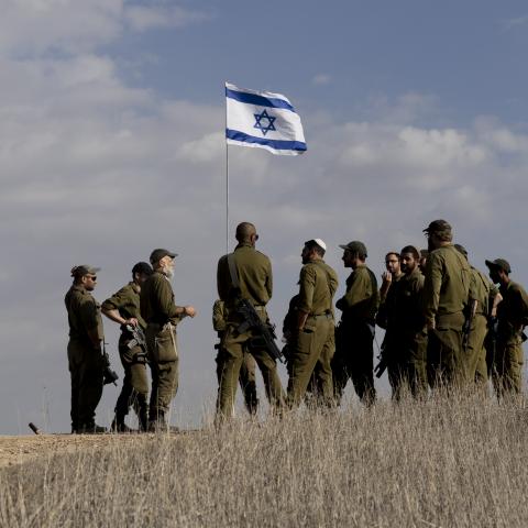Israeli soldiers receive a briefing near the border with the Gaza Strip on December 5, 2024, in Southern Israel. (Amir Levy via Getty Images)