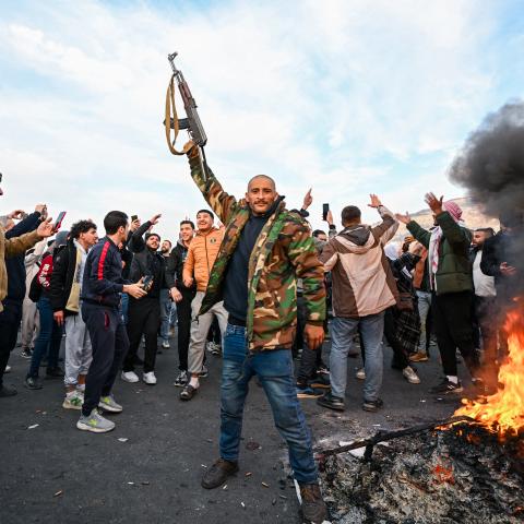People celebrate at Umayyad Square in Damascus, Syria, on December 8, 2024. (Louai Beshara/AFP via Getty Images)