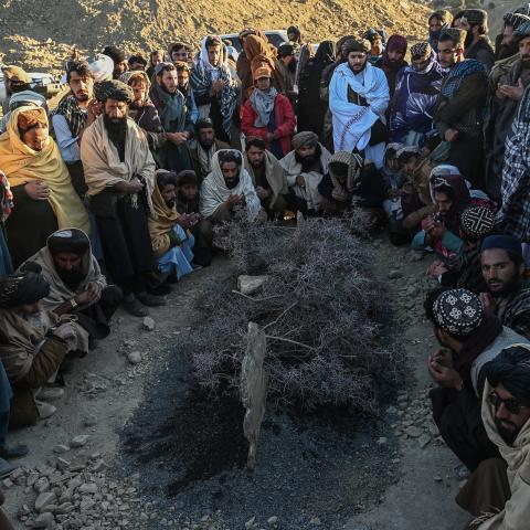 Afghan men gather around the grave of Khalil Ur-Rahman Haqqani during the funeral ceremony in Sarana, Kabul, on December 12, 2024. (Wakil Kohsar via Getty Images)