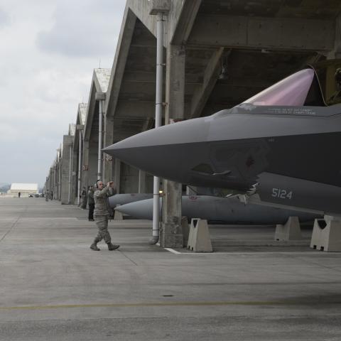 US Air Force Airman 1st Class Austin House, 388th Aircraft Maintenance Squadron crew chief,  marshals an F-35A Lightning II from underneath a hardened facility on January 24, 2018, at Kadena Air  Base, Japan. (US Air Force)