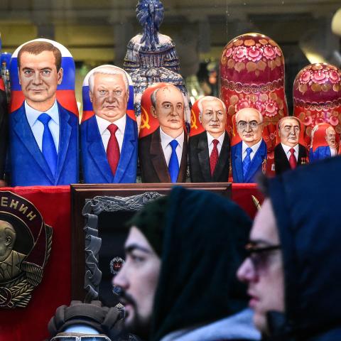 People walk past traditional Russian matryoshka dolls bearing Russian and Soviet leaders in downtown Moscow on December 16, 2018. (Vasily Maximov/AFP via Getty Images)