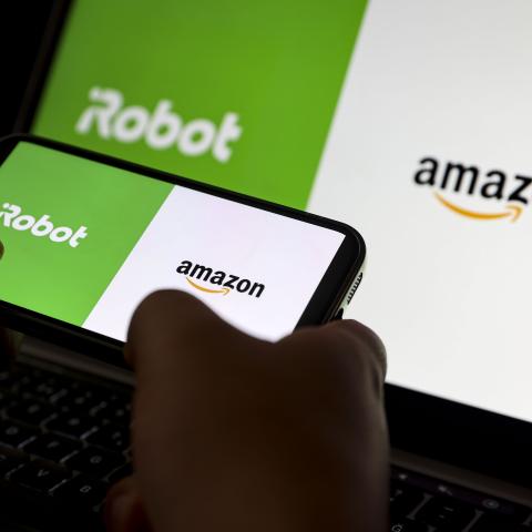 Amazon and iRobot logos are displayed on a mobile phone screen. (Yasin Baturhan Ergin/Anadolu via Getty Images)