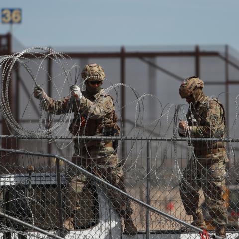 Border patrol officers pull barbed wires as irregular immigrants coming from Central and South America who have gathered in the town of Ciudad Juarez on the Mexican border continue to wait at the US border on March 20, 2024, in Ciudad Juarez, Mexico. (Photo by Christian Torres/Anadolu via Getty Images)