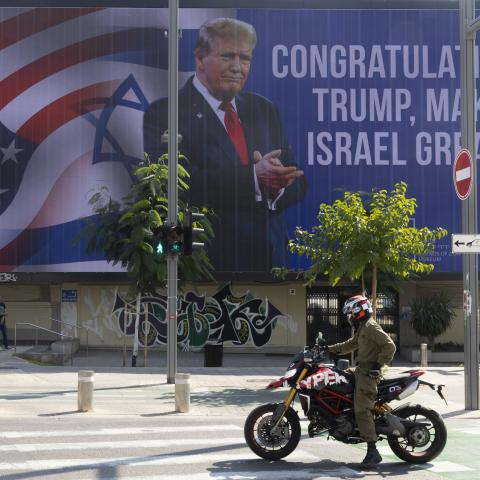 People pass by a congratulatory billboard showing elected United States President Donald Trump on November 7, 2024, in Tel Aviv, Israel. (Amir Levy via Getty Images)