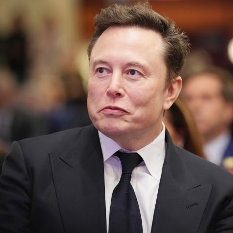 Elon Musk listens as President-elect Donald Trump addresses a House Republicans Conference meeting on November 13, 2024, in Washington, DC. (Andrew Harnik via Getty Images)
