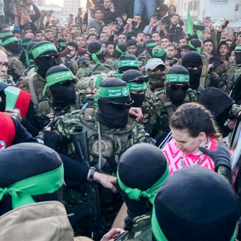 This image grab shows one of the Israeli hostages exiting a vehicle to be handed over to the International Committee of the Red Cross (ICRC) during the hostage-prisoner exchange operation in Saraya Square in western Gaza City on January 19, 2025. The Israeli military said the Red Cross had confirmed the handover of three hostages on January 19, the first to be released as part of a ceasefire deal with Hamas. The Hostage and Missing Families Forum campaign group had identified the three women set to be relea