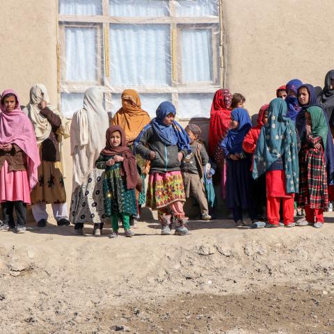 Afghan women and children stand outside a primary healthcare center in Ghazni, Afghanistan, on February 2, 2025. (Mohammad Faisal Naweed/AFP via Getty Images)
