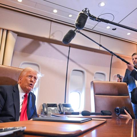 US President Donald Trump speaks to the press aboard Air Force One enroute to New Orleans, Louisiana, on Febrary 9, 2025. (ROBERTO SCHMIDT/AFP via Getty Images)