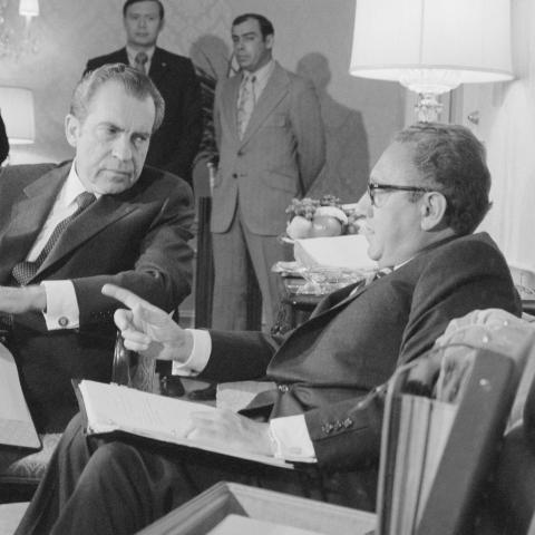 Presidential advisor Henry A. Kissinger gestures as he talks with President Nixon late November 25th at New York's Waldorf Astoria Hotel. The President interrupted a vacation weekend in New York to talk with Kissinger whom he called home from Paris to consult on South Vietnamese objections which appear to have developed into a major road block to a Vietnam settlement.