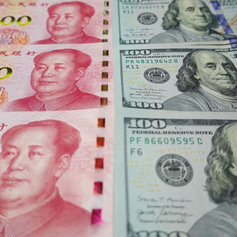 100 US dollar notes and 100 Yuan notes are displayed. (Sheldon Cooper/SOPA Images/LightRocket via Getty Images)