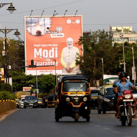 Commuters are passing by Prime Minister Narendra Modi's poster ahead of the Lok Sabha election in Mumbai, India, on April 17, 2024. (Indranil Aditya/NurPhoto via Getty Images)