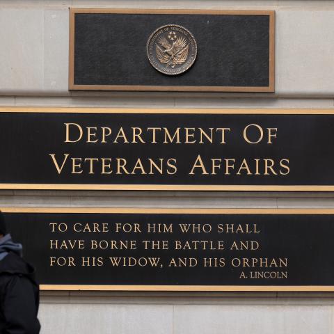 A person walks past the Department of Veterans Affairs headquarters a block from the White House on March 06, 2025 in Washington, DC. As part of President Donald Trump and the Department of Government Efficiency's work to downsize the federal government, Secretary of Veterans Affairs Doug Collins said the department will reduce it's workforce by 15-percent, or about 80,000 jobs. (Photo by Chip Somodevilla/Getty Images)