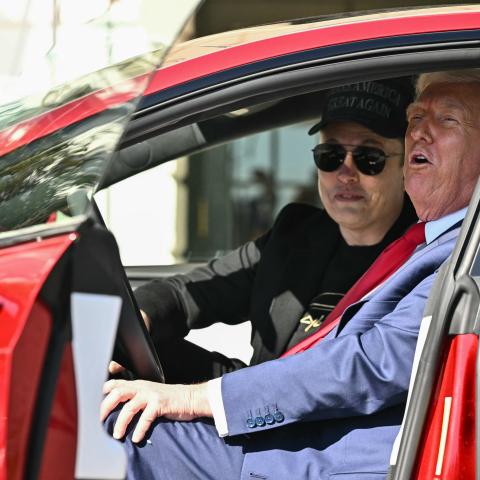 President Donald Trump and Elon Musk speak to the press as they sit in a Tesla vehicle on March 11, 2025, in Washington, DC. (Mandel Ngan/AFP via Getty Images)