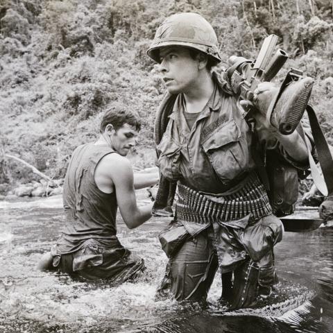 US troops of the 23rd (Americal) Infantry Division ford a river about 11 miles west of Chu Lai in South Vietnam (then the Republic of Vietnam, or RVN), 15th August 1971. The GIs, members of Bravo Company, 4th Battalion, 31st Infantry, are among the last U. S. combat troops still operating in the field. US B-52 aircraft bombed suspected communist troop concentrations near the demilitarized zone, on August 15th, following more shelling and ground assaults earlier on August 15th. More than 750 rounds of mortar