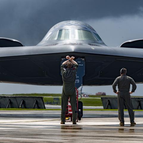 A pilot marshals a B-2 Spirit bomber at Andersen Air Force Base in Guam on June 13, 2024. (US Air Force photo)