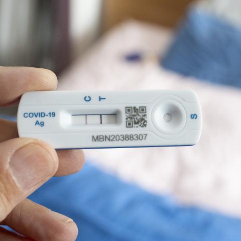 A detail of a hand holding a Covid lateral flow test that shows a positive result in a bedroom, 13th July 2024, in London, England. (Photo by Richard Baker / In Pictures via Getty Images)