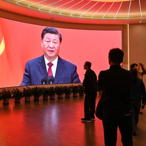 A screen shows images of China's President Xi Jinping in Shanghai on February 27, 2025. (Hector Retamal/AFP via Getty Images)