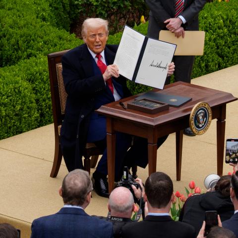 President Donald Trump signs an executive order imposing tariffs on imported goods during a "Make America Wealthy Again" trade announcement event in the Rose Garden, at the White House, on April 2, 2025, in Washington, DC. (Andrew Harnik via Getty Images)