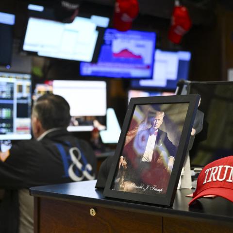 A photograph of President Donald Trump sits on a desk as traders work on the floor of the New York Stock Exchange at the opening bell on April 8, 2025, in New York City. (Getty Images)