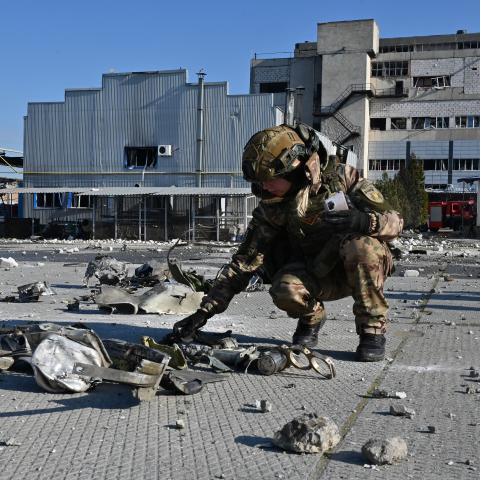 A Ukrainian law enforcement officer inspects the remains of a missile in front of a destroyed perfume and cosmetics manufacturing building following an attack in Kharkiv, Ukraine, on April 18, 2025. (Getty Images)