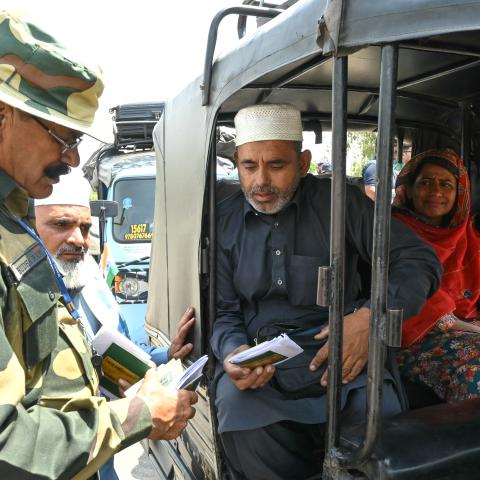 An Indian Border Security Force soldier checks the passports of Pakistani citizens as they return to their country at the India-Pakistan border on the outskirts of Amritsar, India, on April 25, 2025. (Narinder Nanu via Getty Images)