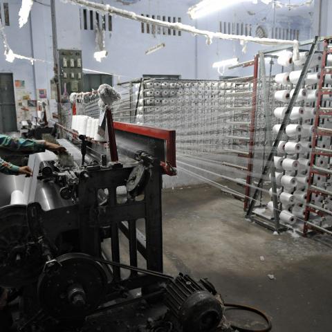 A Pakistani man prepares threads at a textile factory in Gujrat, on April 9, 2009. ( Farooq Naem /AFP via Getty Images)