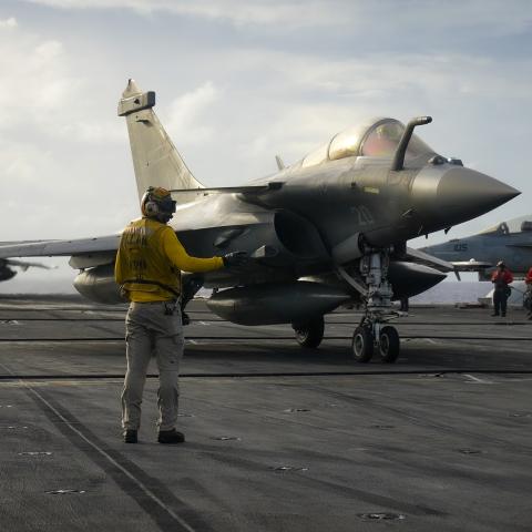 A Sailor directs a Rafale Marine (F4) fighter jet, assigned to the aircraft carrier FS Charles De Gaulle on the flight deck of the aircraft carrier USS Carl Vinson in the Philippine Sea on February 12, 2025. (US Navy photo)