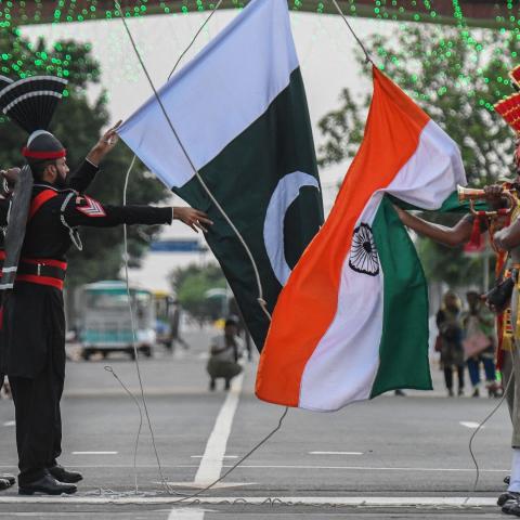 Indian Border Security Force personnel and Pakistani Rangers lower their respective flags during the daily beating retreat ceremony at the India-Pakistan Wagah Post on August 15, 2021. (Narinder Nanu via Getty Images)