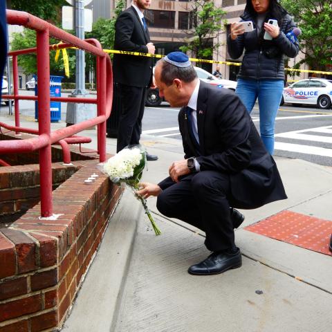 Minister of Economy of Israel Nir Barkat lays flowers at the cordoned-off crime scene in Washington, DC, on May 22, 2025. (Luzia Geier/picture alliance via Getty Images)