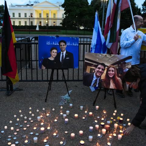A mourner lights a candle during a vigil for the victims of the Capital Jewish Museum shooting outside of the White House on May 22, 2025, in Washington, DC. (Kevin Dietsch via Getty Images)