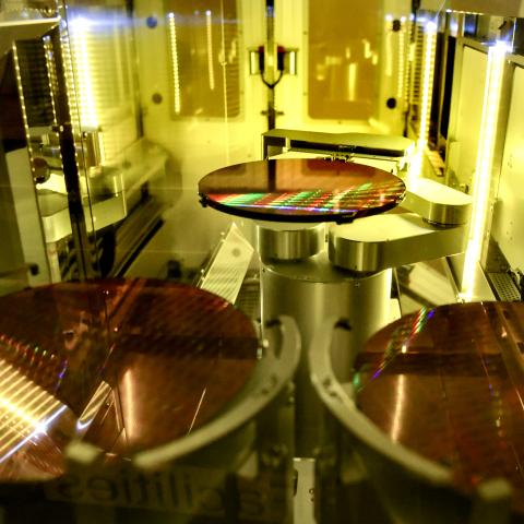 Semiconductor chips are printed onto silicon wafers and loaded into containers in the clean room at GlobalFoundries Fab 8 in Malta, New York, on June 10, 2021. (Cindy Schultz via Getty Images)
