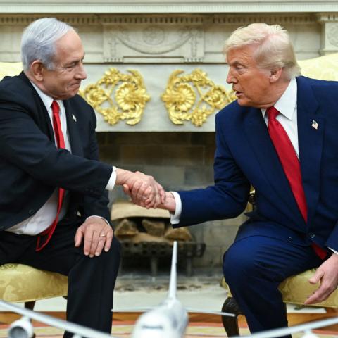 US President Donald Trump shakes hands with Israeli Prime Minister Benjamin Netanyahu during a meeting in the Oval Office of the White House in Washington, DC, on April 7, 2025. (Saul Loeb via AFP)