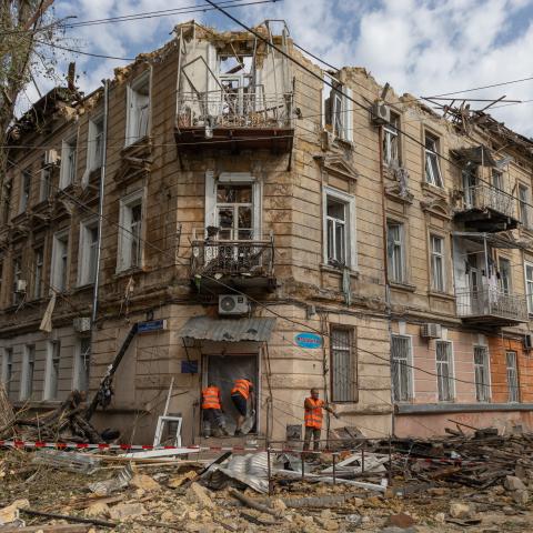 Communal workers clean debris next to a damaged residential building following a Russian drone attack in Odesa, Ukraine, on June 10, 2025. (Oleksandr Gimanov via Getty Images)