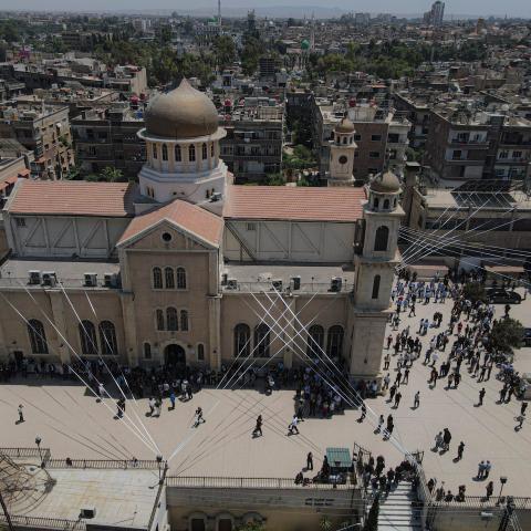 An aerial view shows a mass funeral ceremony being held at the Holy Cross Church in the Al-Qassaa neighborhood of Damascus, Syria, on June 24, 2025. (Izettin Kasim via Getty Images)