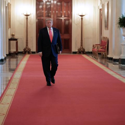 United States President Donald Trump walks through the Cross Hall as he arrives for a "One, Big, Beautiful" event in the East Room of the White House on June 26, 2025, in Washington, DC. (Chip Somodevilla via Getty Images)