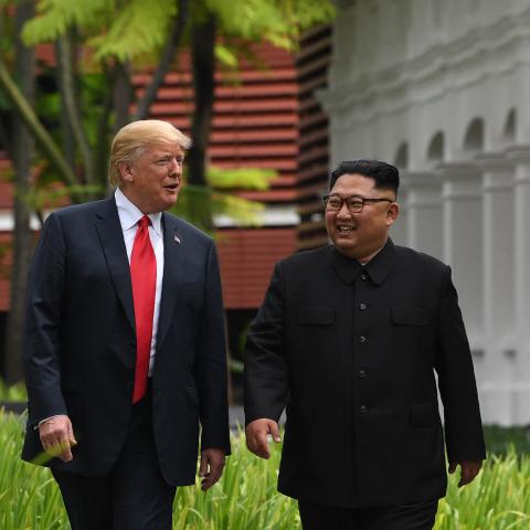 North Korea's leader Kim Jong Un walks with US President Donald Trump during a break in talks at their historic US-North Korea summit, at the Capella Hotel on Sentosa island in Singapore on June 12, 2018. (Saul Loeb via Getty Images)