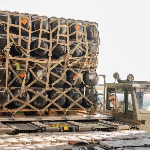 A US airman loads ammunition, weapons, and other equipment bound for Ukraine during a foreign military sales mission at Dover Air Force Base, Delaware, on February 10, 2022. (US Air Force photo by Mauricio Campino)