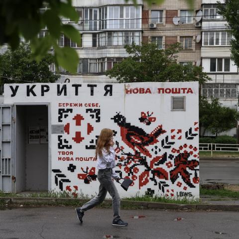 A woman walks past a concrete shelter painted in the style of Ukrainian embroidered ornamentation in a residential district on May 17, 2025 in Kherson, Ukraine. (Photo by Ivan Antypenko/Suspilne Ukraine/JSC "UA:PBC"/Global Images Ukraine via Getty Images)