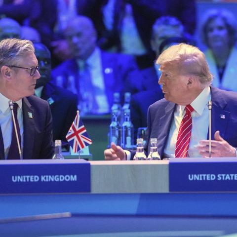 US President Donald Trump speaks to UK Prime Minister Keir Starmer at a North Atlantic Council plenary meeting during the NATO summit on June 25, 2025, in The Hague, Netherlands. (Kin Cheung via Getty Images)