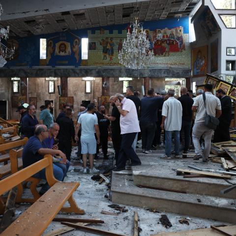 People survey the scene following a blast in the Mar Elias Church on June 22, 2025, in Damascus, Syria. A suspected suicide bombing killed at least 20 people and injured 52 others who were attending a service at the church. (Ali Haj Suleiman via Getty Images)