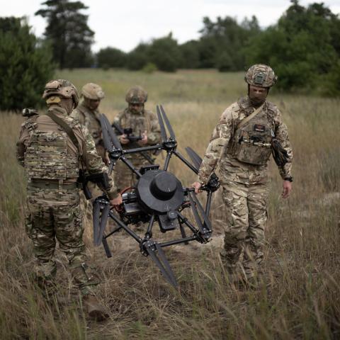 Ukrainian soldiers calibrate an agricultural drone, transformed into a front-line delivery system, during a demonstration at an undisclosed location near Dnipropetrovsk, Ukraine, on June 14, 2025. (Florent Vergnes via Getty Images)