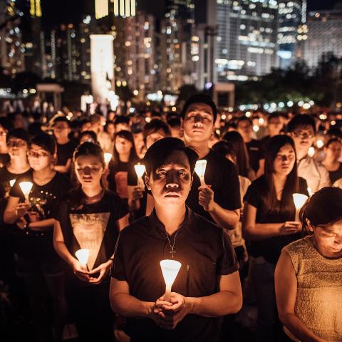 Participants take part at the candlelight vigil as they hold candles at Victoria Park on June 4, 2015, in Hong Kong. (Anthony Kwan via Getty Images)