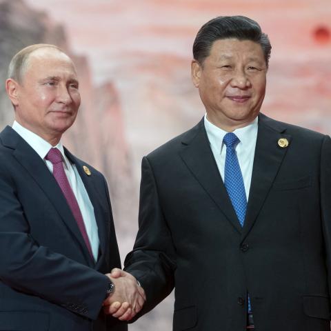 President Vladimir Putin shakes hands with President Xi Jinping during a welcoming ceremony at the Shanghai Cooperation Organization Council of Heads of State in Qingdao, China, on June 10, 2018. (Sergei Guneyev via Getty Images)