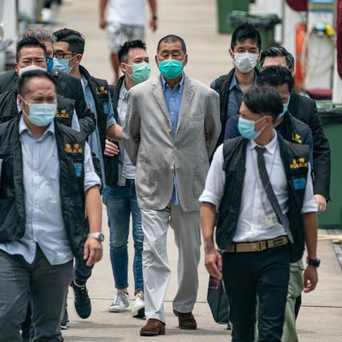 Hong Kong media tycoon and Apple Daily founder Jimmy Lai is escorted by the police to the Royal Hong Kong Yacht Club Shelter Cove Clubhouse for evidence collection as part of the ongoing investigations on August 11, 2020, in Hong Kong, China. (Anthony Kwan via Getty Images)