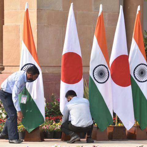 Workers arrange national flags of Japan and India ahead of a meeting between Indian Prime Minister Narendra Modi and Japanese Prime Minister Fumio Kishida at Hyderabad House on March 19, 2022, in New Delhi, India. (Sonu Mehta via Getty Images)